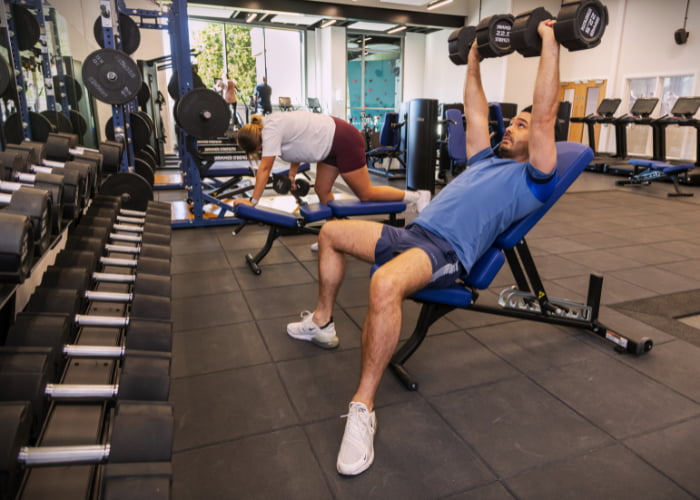 Working out using dumbbells on the benches